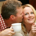 Couple enjoys a hot cup of coffee in the kitchen