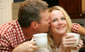 Couple enjoys a hot cup of coffee in the kitchen