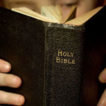 Holy Bible Being Held Binding Facing Wide Pic