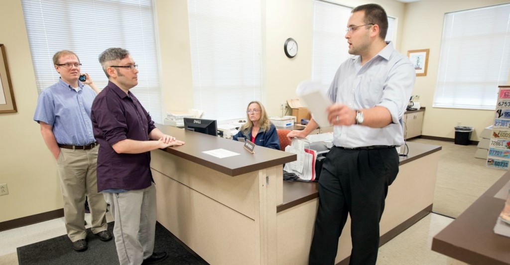 Rowan County Deputy Clerk Nathan Davis, right, informs David Moore, center, and David Ermold, left, that he won't issue them a marriage license Thursday, August 13, 2015 at the Rowan County Clerk's office in Morehead, Ky. Moore and Ermold were at the courthouse early Thursday following an order by a federal judge that Rowan County Clerk Kim Davis issue the licenses, despite her religious convictions. (John Flavell/Lexington Herald-Leader/TNS)