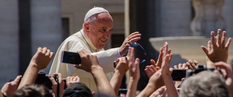 Pope Francis waving to crowd smiling outside sunny