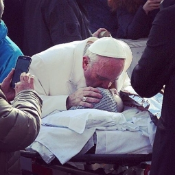 Pope Francis Kisses a Child