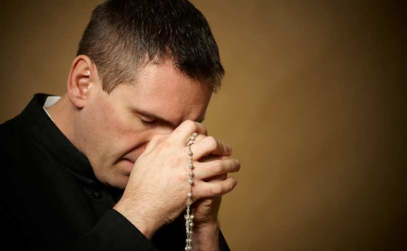 Priest Praying with Rosary