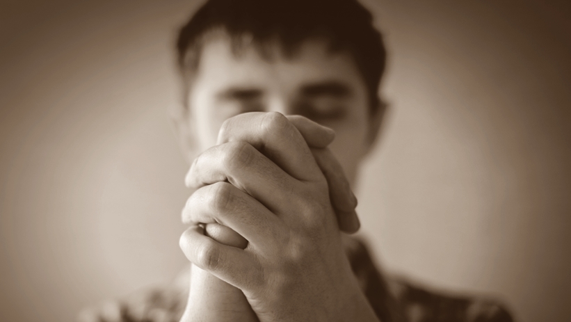 Man Praying Eyes Closed Black and White pic