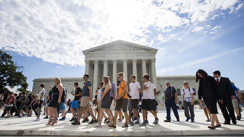 Visitors walk past the U.S. Supreme Court building in Washington June 15. The high court announced in November it will hear appeals from religious groups in their legal challenge of the Obama administration's contraceptive mandate. (CNS photo/Jim Lo Scalzo, EPA) See YEAREND-MANDATE Nov. 25, 2015.